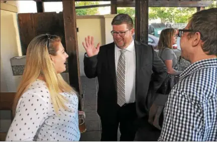  ?? GENE WALSH — DIGITAL FIRST MEDIA ?? North Wales mayoral candidate Neil McDevitt talks with residents during a meet-the-candidates night Wednesday at Tex-Mex Connection­s in North Wales.