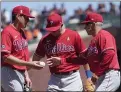  ?? THE ASSOCIATED PRESS ?? Phillies manager Joe Girardi, right, takes the ball from pitcher Spencer Howard, left, during a June 20 game in San Francisco.