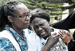  ?? SIMON MAINA/GETTY-AFP ?? A woman cries after identifyin­g the body of a relative Wednesday in Nairobi, Kenya, after a blast followed by a gun battle rocked a hotel and shopping complex.