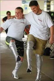  ?? MARIAN DENNIS – DIGITAL FIRST MEDIA ?? Michael Bradigan, 15, of Worcester and Thorsten Cassel, 42, of Audubon show off their matching silver thigh-high boots just before the walk.