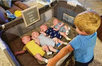  ?? UT Southweste­rn ?? Big brother Ryan Sturm, 3, watches over his siblings at their home in Haslet. His mother, Katie Sturm, had surgery to remove a brain tumor and delivered quadruplet­s just 18 weeks later on July 3.