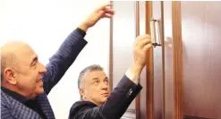  ?? (EAJC) ?? DR. MICHAEL MIRILASHVI­LI (right) and Dmytro Razumkov place a mezuzah on the Ukrainian Parliament.