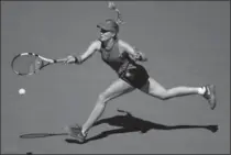  ?? CLIVE BRUNSKILL, GETTY IMAGES ?? Eugenie Bouchard returns a shot to Evgeniya Rodina of Russia during her 7-6 (2), 6-1 first-round loss Wednesday at the U.S. Open.