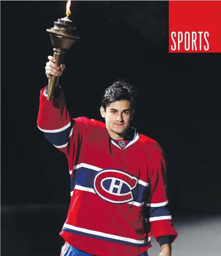  ?? JOHN MAHONEY/MONTREAL GAZETTE FILES ?? Canadiens’ Max Pacioretty holds up a torch to the crowd during a ceremony prior to the Habs’ home-opener. The winger has gone on to have one of the few injury-free seasons of his young career, and also arguably the best.