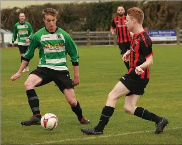  ??  ?? Paul Brennan of Gorey Rangers closes in on Jakub Konkel of Gorey Celtic.