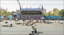  ?? AFP ?? Injured soldiers lying on the ground at the scene of the attack in southern Iran on Saturday.