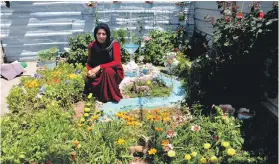  ?? AFP; Lemon Tree Trust ?? Syrian musician Maya Youssef arrives with her qanun to play in the Lemon Tree Trust Garden, inspired refugees living in Domiz camp in Iraq, main picture. Garden competitio­n winners clockwise, from far left: Ezdin Abdullah; Zahra Alsaid Rasul; Khalaf...