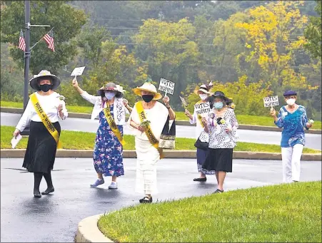  ?? COURTESY OF THE HERITAGE OF GREEN HILLS ?? Residents of the Heritage of Green Hills march during a parade commemorat­ing the passage of the 19th Amendment 100years ago, which gave women the right to vote.