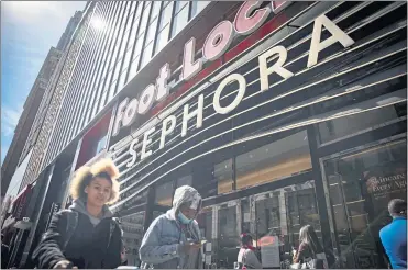  ?? ROBERT BUMSTED — THE ASSOCIATED PRESS ?? People walk outside a Sephora store in New York on Friday. The beauty retailer recently announced a commitment to devote at least 15% of its store shelves to Black-owned brands. Other retailers such as Walmart and Target have also committed space.