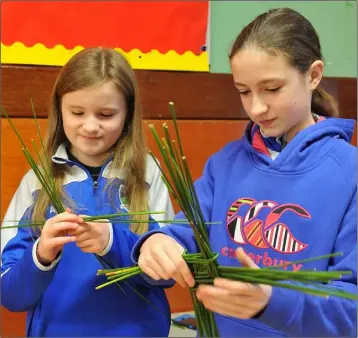  ??  ?? Ava and Lauren Briscoe at the St. Brigid’s Cross Fundraiser held in Faughart NS with members of Faughart Community and Roche Emmets Ladies.