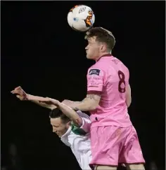  ??  ?? Craig Wall beats Jack Watson of Cabinteely in the air.