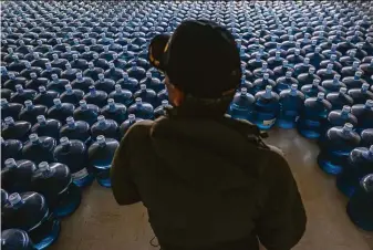  ?? Nathan Howard / Associated Press ?? Dan Martinez, emergency manager for the Confederat­ed Tribes of Warm Springs, Ore., hands out about 3 million gallons of water — almost all of it donated — to reservatio­n residents.