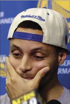  ??  ?? Golden State Warriors’ Stephen Curry listens to a question Monday in Oakland, the day after the Cleveland Cavaliers defeated the Warriors in basketball’s NBA Finals. AP PHOTO