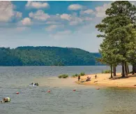  ?? Submitted photo ?? ■ Visitors to DeGray Lake Resort State Park enjoy some time in the water and along the beach at the recreation area in this undated photo courtesy of Arkansas State Parks. DeGray Lake Resort State Park will be hosting its annual Shoreline Sweep Cleanup on April 1.