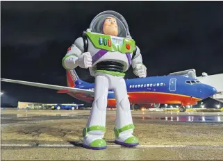 ?? PHOTOS COURTESY OF JASON WILLIAM HAMM ?? Jason William Hamm, a Southwest Airlines ramp agent, took photos of Buzz Lightyear on the tarmac and around the plane in an effort to chronicle the action figure’s adventure for Hagen Davis.