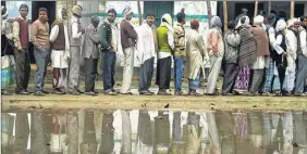  ?? VINAY PANDEY / HT PHOTO & REUTERS ?? People await their turn to vote at a polling station in Shravasti town in Uttar Pradesh on Wednesday; (left) young voters display their voter ID cards in Faizabad