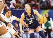  ?? C. Morgan Engel / NCAA Photos via Getty Images ?? UConn’s Azzi Fudd of the Connecticu­t Huskies tries to dribble to the basket while defended by South Carolina’s Zia Cooke during Sunday’s national championsh­ip game. Fudd was limited to just 17 minutes becasuse of an illness.