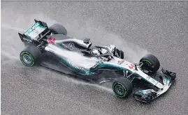 ?? DARREN ABATE/THE ASSOCIATED PRESS ?? Mercedes driver Lewis Hamilton put up the fastest time in the first practice session for the Formula One U.S. Grand Prix at the Circuit of the Americas on a rainy day Friday in Austin, Texas. The race is set for Sunday.