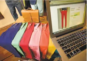  ?? Noah Berger / Special to The Chronicle 2013 ?? Roselands pants line a table at Bonobos Guideshop in San Francisco in 2013. Walmart recently purchased the clothing label.