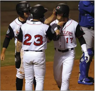  ?? (Arkansas Democrat-Gazette/Thomas Metthe) ?? Jake Fraley (17) of the Arkansas Travelers gets a tug on his beard from teammate Jordan Cowan after Fraley hit a home run in the Travelers’ home opener a year ago. The Travelers, like the rest of the teams in minor-league baseball, have yet to play this season because of the coronaviru­s pandemic. Travelers General Manager Paul Allen said he hopes the Travelers can have a season, but remains realistic one might not be played.