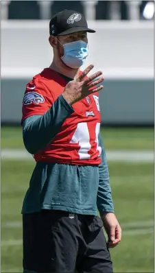  ?? MEDIANEWS GROUP PHOTO ?? So far, so good for NFL players almost completely staying virus-free during training camps. But now with the season about to start, the masks, like this one on Eagles quarterbac­k Carson Wentz, will come off and some social distancing is completely out the window. It will be harder to keep coronaviru­s out of the conversati­on.