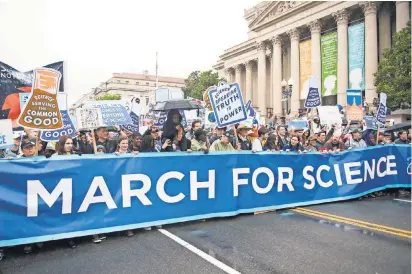  ?? PHOTOS BY JASPER COLT, USA TODAY ?? Marchers carry a banner at the head of the March for Science rally Saturday in Washington.