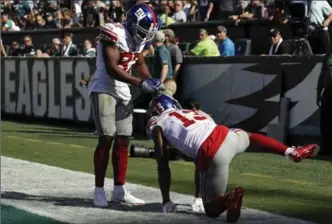  ?? ASSOCIATED PRESS FILE PHOTO ?? Odell Beckham takes National Football League touchdown celebratio­ns to ... well ... new levels.