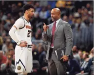  ?? David Zalubowski / Associated Press ?? Denver Nuggets guard Jamal Murray (27) confers with assistant coach Wes Unseld Jr. in the first half of a game in 2020. The Washington Wizards have named Wes Unseld Jr. as their next head coach. The Denver Nuggets associate coach is the son of Washington basketball legend Wes Unseld, whose number is retired and hangs in the rafters. Unseld Jr. replaces Scott Brooks who was fired after three playoff appearance­s in five seasons.