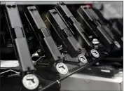  ?? PHOTO BY BING GUAN, REUTERS ?? Glock semi-automatic pistols are displayed at a gun store in Oceanside on April 12.