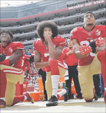  ?? Marcio Jose Sanchez Associated Press ?? COLIN KAEPERNICK, center, inspired others in 2016 when he began kneeling during the national anthem.