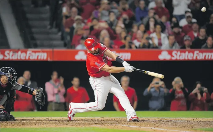  ?? — THE ASSOCIATED PRESS FILES ?? Los Angeles Angels’ Albert Pujols hits a grand slam, his 600th career homer, as Minnesota Twins catcher Chris Gimenez watches Saturday in Anaheim.