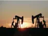  ?? — Reuters ?? Pump jacks operate at sunset in an oilfield in Midland, Texas.