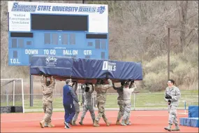  ?? Kathy Willens / Associated Press ?? Connecticu­t Air and Army National Guard personnel move pole vault and high-jump mats to an outdoor field to make room inside Moore Field House for a temporary field hospital to be constructe­d for the current coronaviru­s crisis at Southern Connecticu­t State University on March 31. in New Haven.