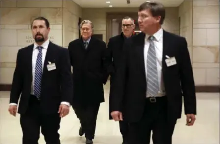  ?? JACQUELYN MARTIN — THE ASSOCIATED PRESS ?? Former White House strategist Steve Bannon, second from left, is escorted from a House Intelligen­ce Committee meeting where he was interviewe­d behind closed doors on Capitol Hill, Tuesday in Washington.