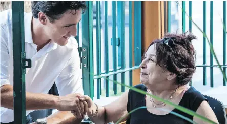  ?? FREDERIC HORE/ MONTREAL GAZETTE ?? Liberal Leader Justin Trudeau talks with Tazi Najat, of Rosemere, Que., in Montreal Friday. Trudeau decried the waste of taxpayer funds in a rumoured Sunday election call. “I look forward to the opportunit­y to challenge my opponents,” he said.