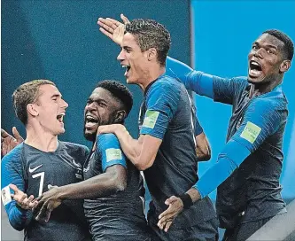  ?? MARTIN MEISSNER THE ASSOCIATED PRESS ?? France's Samuel Umtiti, second from left, is congratula­ted by Antoine Griezmann, Raphael Varane and Paul Pogba after scoring against Belgium in Tuesday’s World Cup soccer semifinal.