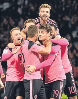  ?? Picture: SNS. ?? Scotland’s players celebrate their last-gasp winner against Slovakia on Thursday night. They may be celebratin­g having clinched a play-off place tomorrow.