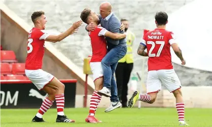  ?? Photograph: Martin Rickett/PA ?? Gerhard Struber embraces his Barnsley players after Patrick Schmidt’s later winner against Nottingham Forest that gave the club a chance of avoiding relegation from the Championsh­ip.