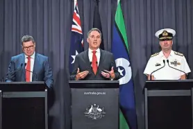  ?? LUKAS COCH/AAP IMAGE VIA AP ?? Australian Defense Industry Minister Pat Conroy, left, Defense Minister Richard Marles and nuclear submarine task force head Vice Adm. Jonathan Mead, speak Tuesday in Canberra, Australia. Marles said the submarine deal was necessary to counter the biggest convention­al military buildup in the region since World War II.