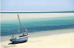  ?? / ISTOCK ?? A dhow at the water’s edge on a beach in Mozambique, one of the places Dougray Scott has visited.