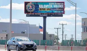  ?? SUSAN STOCKER/SOUTH FLORIDA SUN SENTINEL ?? A digital billboard which tells the public to report tips related to the US. Capitol violence to the FBI is seen Tuesday along I-95 near Hallandale Beach Boulevard.