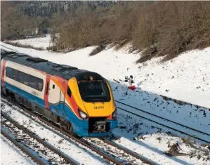  ?? PETER FOSTER. ?? East Midlands Trains 222013 passes a snowy Souldrop (Bedfordshi­re) on December 12, with the 1005 Nottingham-St Pancras Internatio­nal. Under new plans this train could lose its stops south of Kettering.