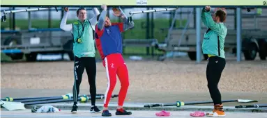  ??  ?? One of the team: James Cracknell, in his Olympic kit, helps carry the boat