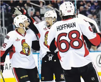  ?? GETTY IMAGES FILE PHOTO ?? Mike Hoffman of the Ottawa Senators celebrates with teammates Clarke MacArthur, left, and Erik Karlsson after scoring a goal against Henrik Lundqvist of the New York Rangers during the 2017 Stanley Cup playoffs.