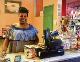  ?? BILL TORPY/WILLIAM.TORPY@AJC.COM ?? Chloe Floyd runs the Pyramid Grocery store at Floyd’s Plaza in Atlanta’s Pittsburgh community. She says the family gets lots of offers from investors but isn’t interested in selling. Her family has owned the property since the 1990s.
