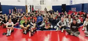  ?? Contribute­d photo ?? Wrestlers gather during the first Queen of the Mat girls wrestling tournament, held at Foran in Milford on Sunday.