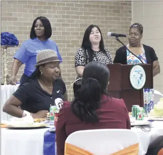  ?? Katie West • Times-Herald ?? Volunteers with Bright Futures spoke about the program during a banquet held recently to officially begin the coordinate­d effort in St. Francis County. From left, LaSandra Ward-Bean, Ashley Boone and Dorothy Kiyumbi share informatio­n about the program during the banquet.