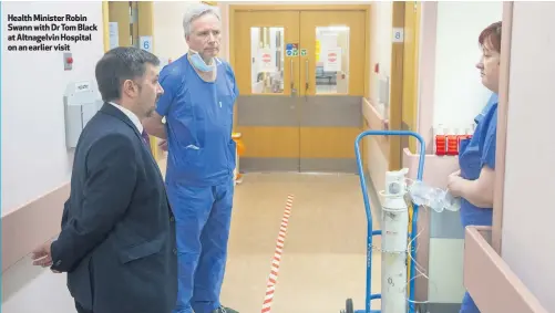  ??  ?? Health Minister Robin Swann with Dr Tom Black at Altnagelvi­n Hospital on an earlier visit