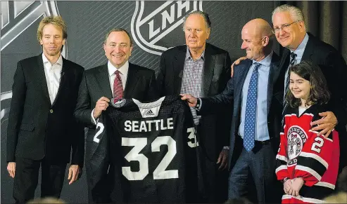  ?? — AP ?? Joining NHL commission­er Gary Bettman on stage yesterday to announce Seattle as the league’s 32nd franchise are, from left, Jerry Bruckheime­r, David Bonderman, David Wright, Tod Leiweke and Washington Wild youth player Jaina Goscinski.