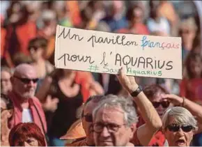  ?? AFP PIC ?? A protester holding a sign reading ‘The French Flag for Aquarius’ in support of the ‘Aquarius’, a boat dedicated to the rescue of migrants at sea, in Marseille on Saturday.